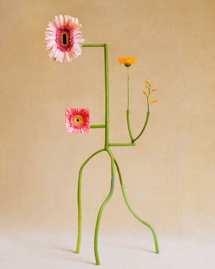 Jennifer Latour photo shows intricate flower composition resembling a figure with pink and orange blooms.