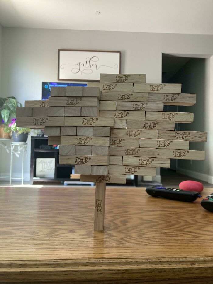 A freestanding Jenga tower defying gravity, appearing to make absolutely no physical sense with its baffling construction.