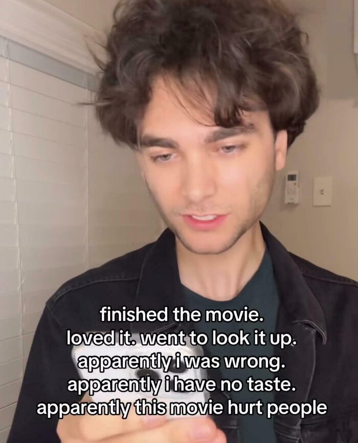 A funny meme shows a person looking at their phone, expressing surprise about a movie's reception after enjoying it.