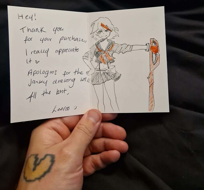 Hand holding a thank you note with a Vinted post drawing, showing unhinged Vinted posts.