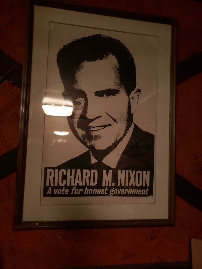 A framed campaign poster for Richard M. Nixon, showing how political beliefs and words age.