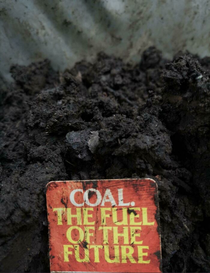 Coal, The Fuel of the Future sign in a pile of coal, illustrating how beliefs and words will age over time.