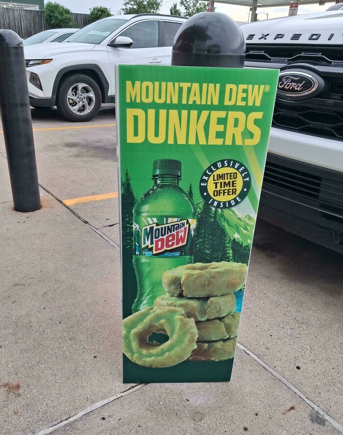 An outdoor sign advertising Mountain Dew Dunkers donuts, a truly bizarre thing to take a photo of.
