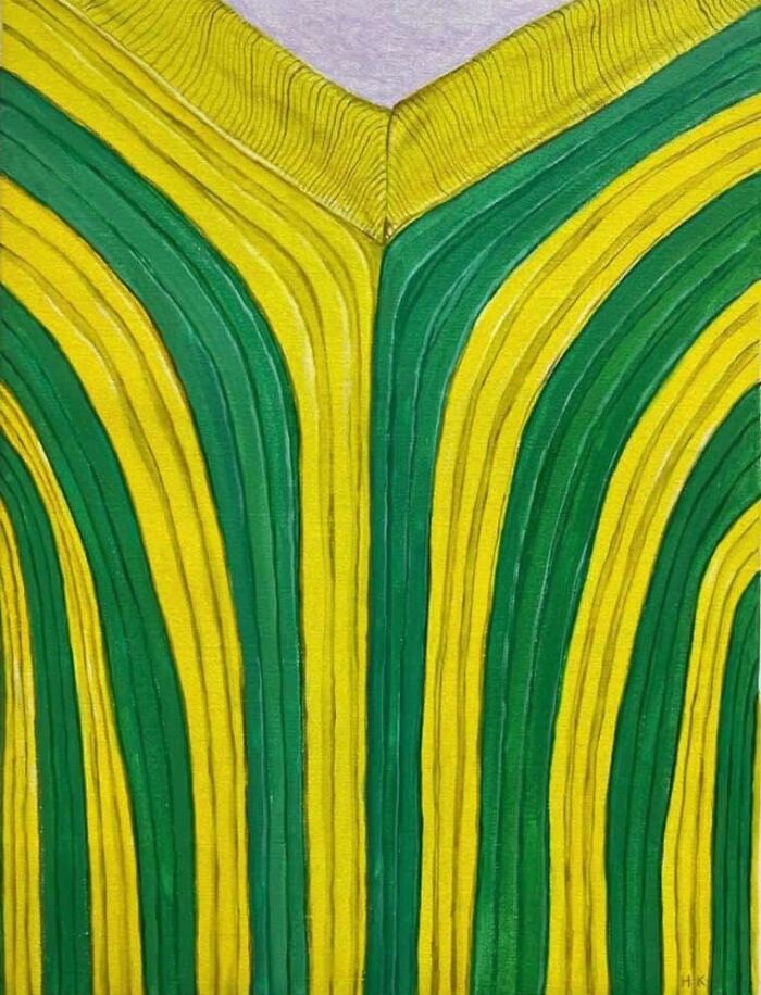 A striking portrait of identity showing a yellow and green striped jumper with unique texture and color.