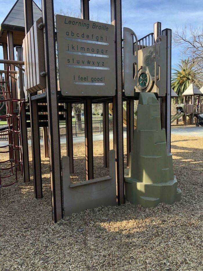 A playground with a braille sign too high to read, a clear playground fail in accessibility and design.