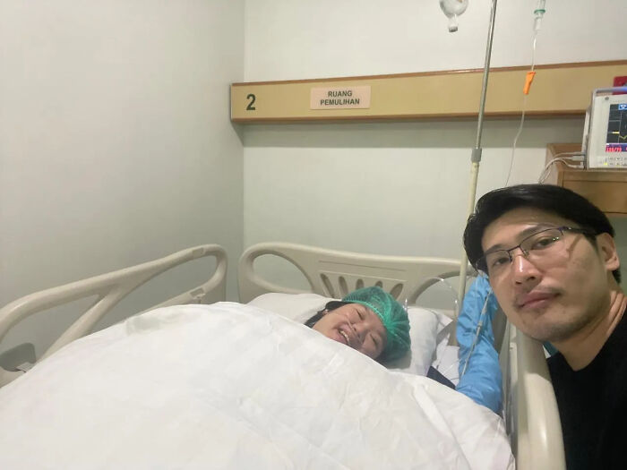 A man taking a selfie with his partner in a hospital bed, sweet proof they found the right man.