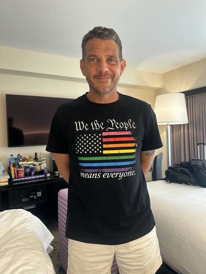 A man wearing a We the People t-shirt, a sweet proof of his values and being the right man.