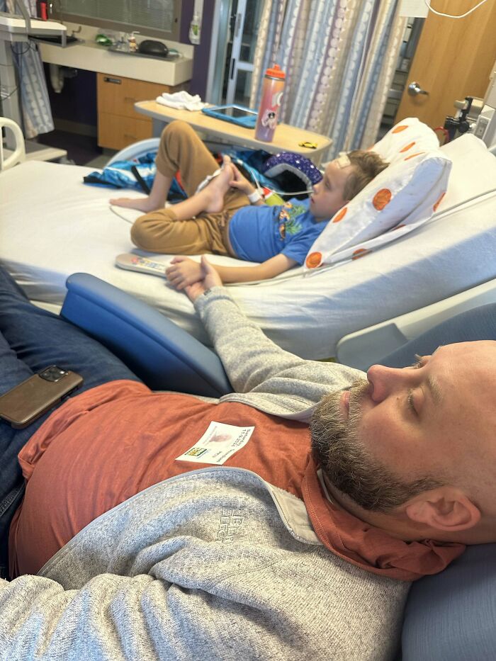 A father holds his child's hand in a hospital, a sweet proof of finding the right man.