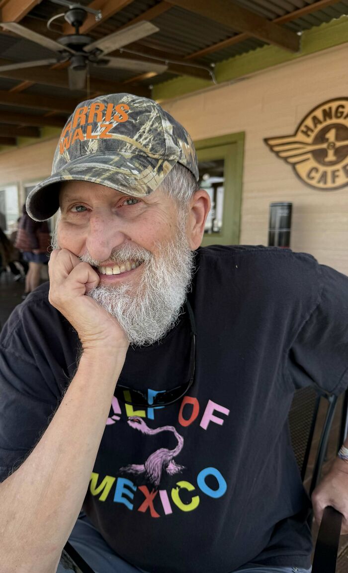 A smiling older man in a camo hat, sweet proof of a lasting love where a woman found the right man after 40 years.