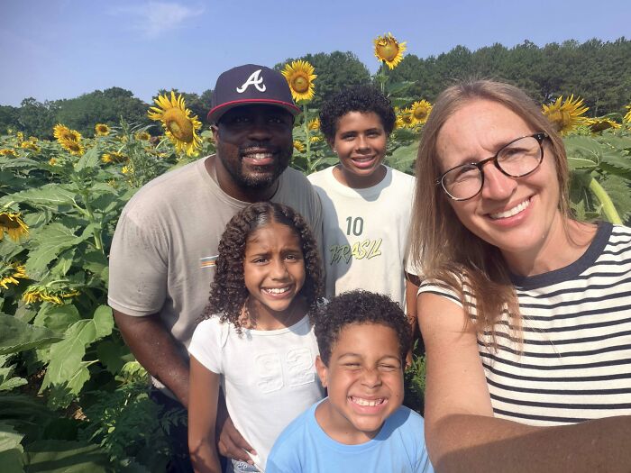A happy family in a sunflower field, sweet proof a woman found the right man, enjoying life after 40 years together.