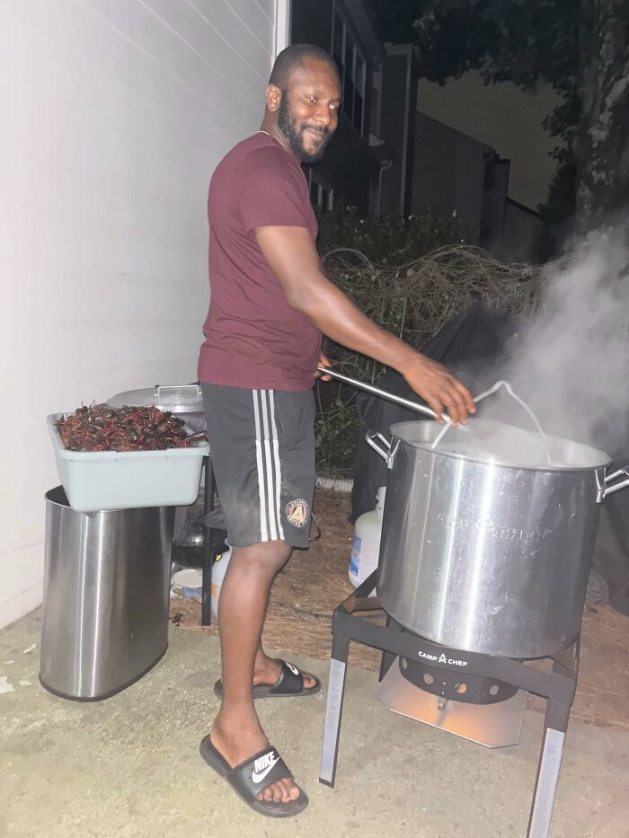 A man cooking outdoors at night, a sweet proof he's the right man for her.