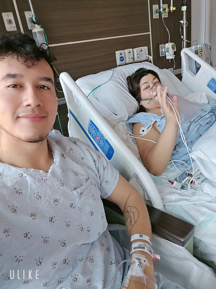 A man sitting next to a woman in a hospital bed, sweet proof they found the right man.