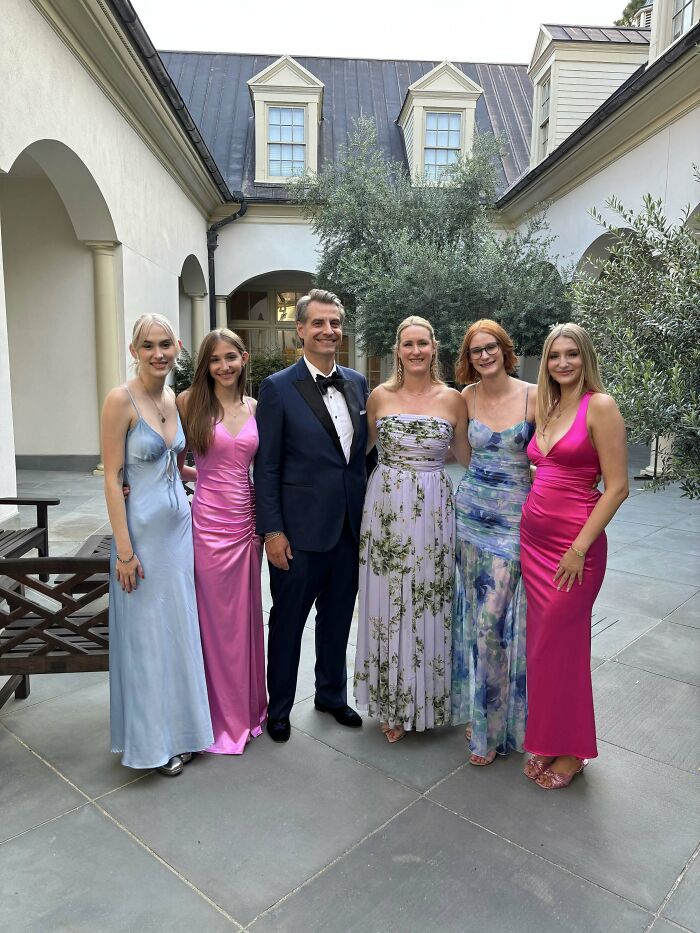 A family dressed in formal attire, showcasing the sweet proof of finding the right man.