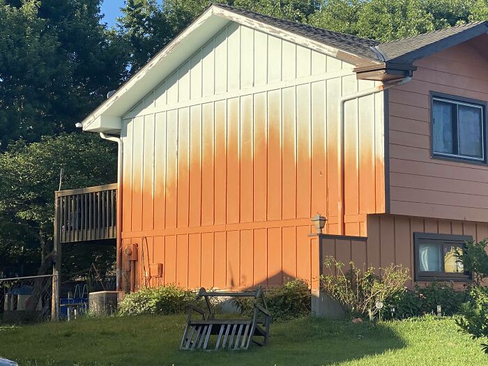A house with a questionable home improvement project, featuring paint that appears to be melting down the siding.