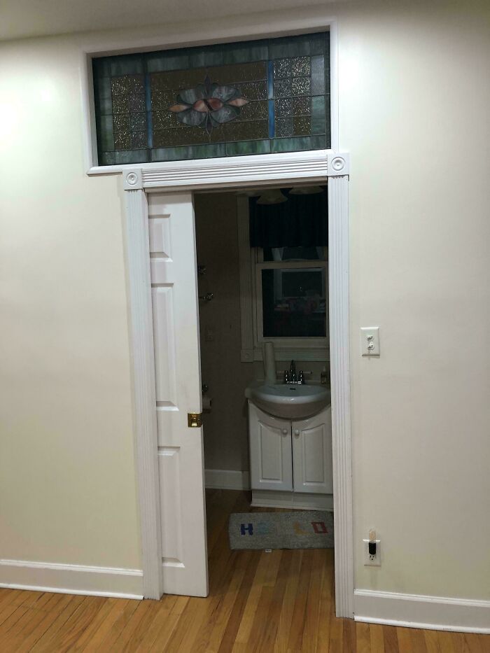 A small bathroom vanity visible through a narrow doorway, highlighting questionable home improvement decisions.