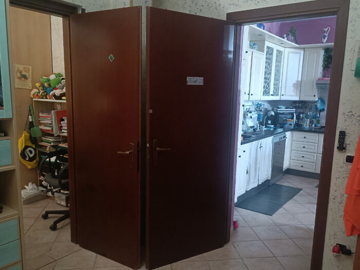 A poorly installed pair of double doors blocking a hallway, showing questionable home improvement.