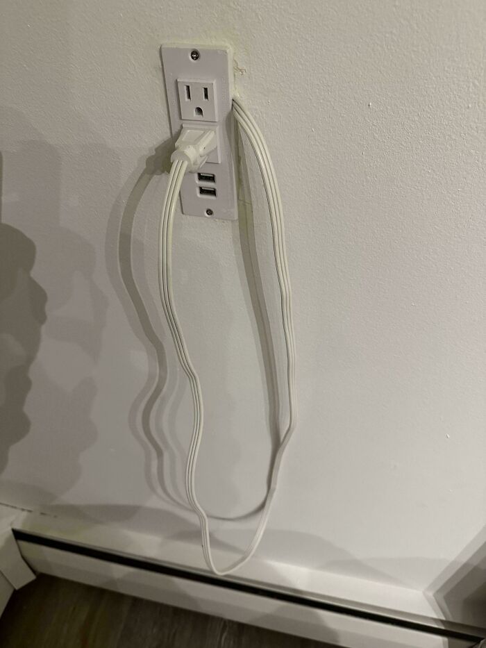 An electrical outlet with multiple USB cables plugged in, demonstrating questionable home improvement projects.