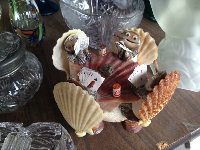 An unhinged secondhand find: seashell figures playing cards around a shell table.