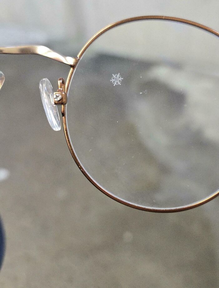 Mildly interesting picture of a perfect snowflake on a pair of glasses, a unique winter sight.