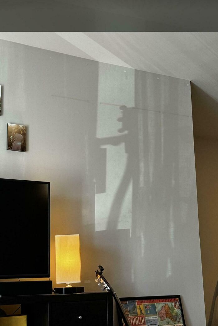 A quirky shadow figure projected on a white wall, making for a mildly interesting picture.