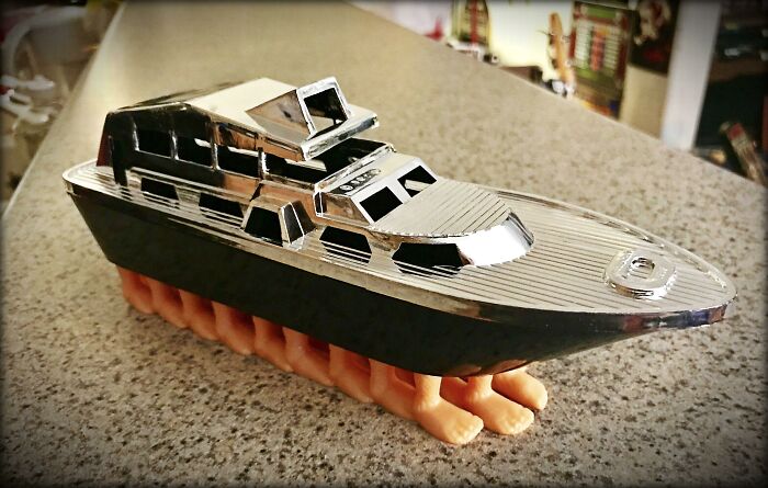 A toy yacht with human feet for a base, an example of unhinged secondhand finds.