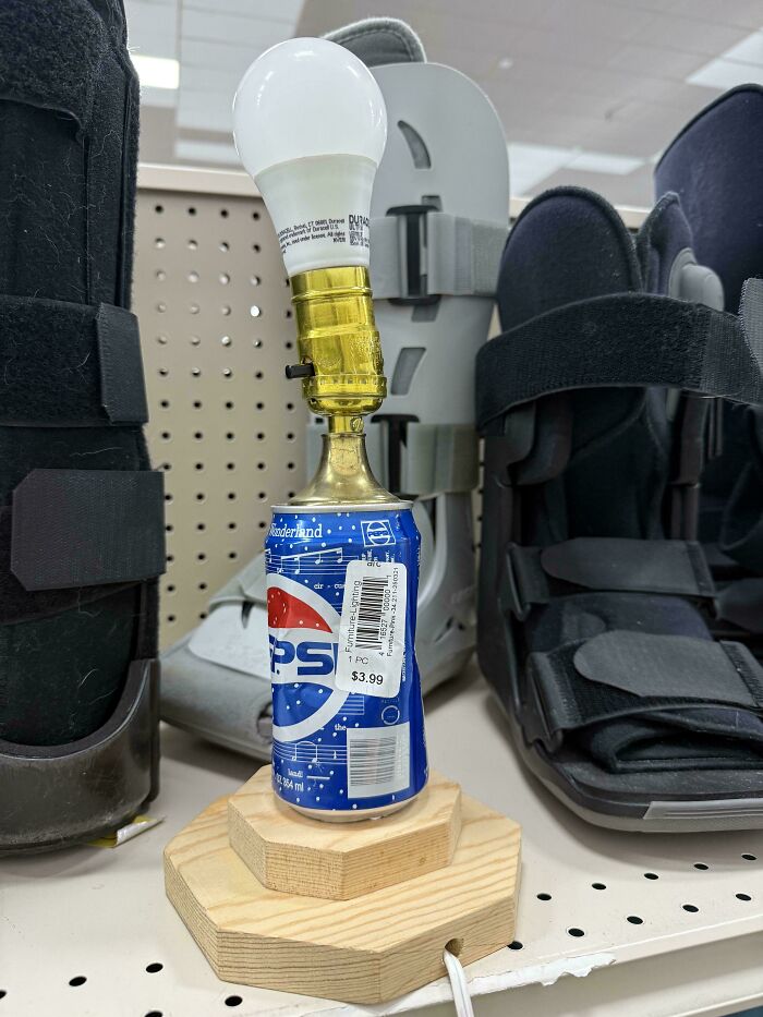 A lamp made from a Pepsi can and a light bulb, an example of cursed secondhand finds.