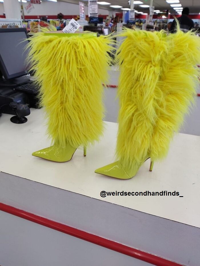 A pair of unhinged secondhand fluorescent yellow furry boots on display.