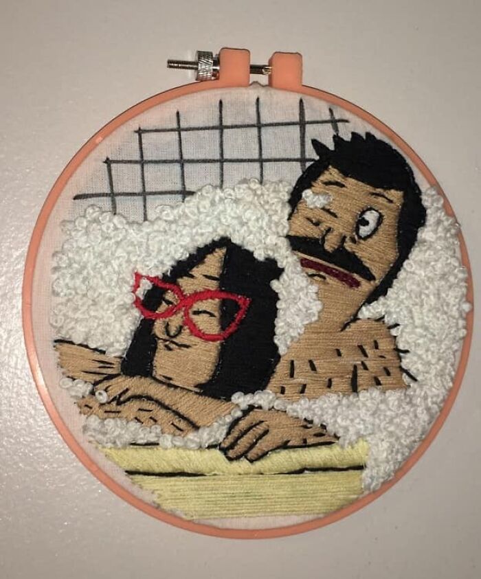An embroidered artwork of a couple in a bubble bath, a unique secondhand find.