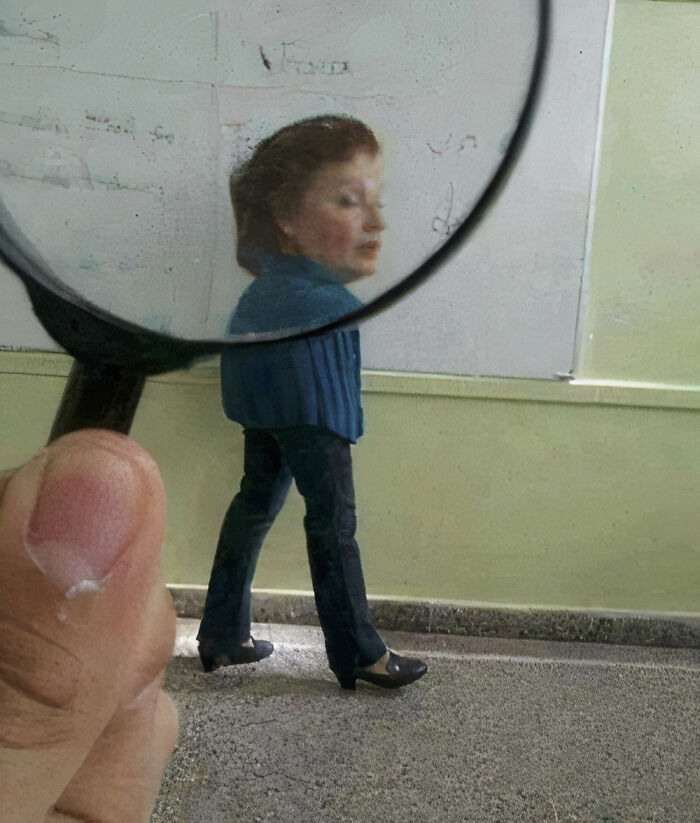 Hilarious photos: A person views a woman with a small body and large head through a magnifying glass.