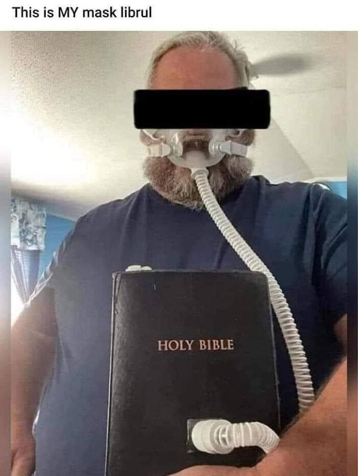 A man wearing a CPAP mask connected to a Bible, shared as unhinged content on social media.