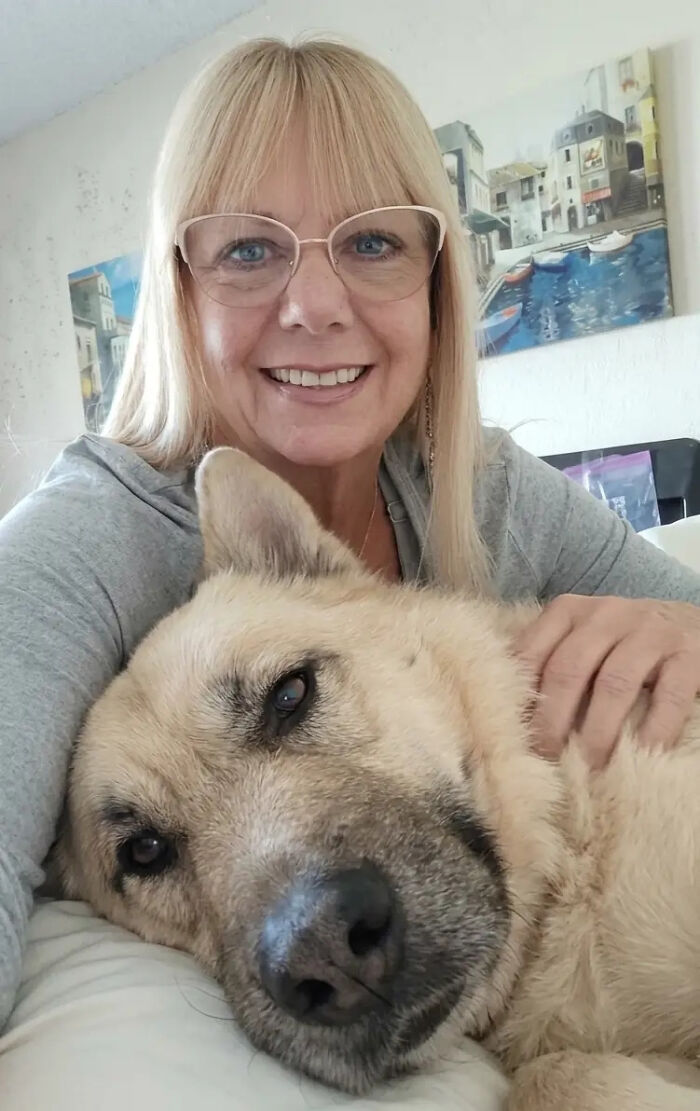 A woman smiling with her golden retriever, sharing stories that swear are 100% true, not AI.