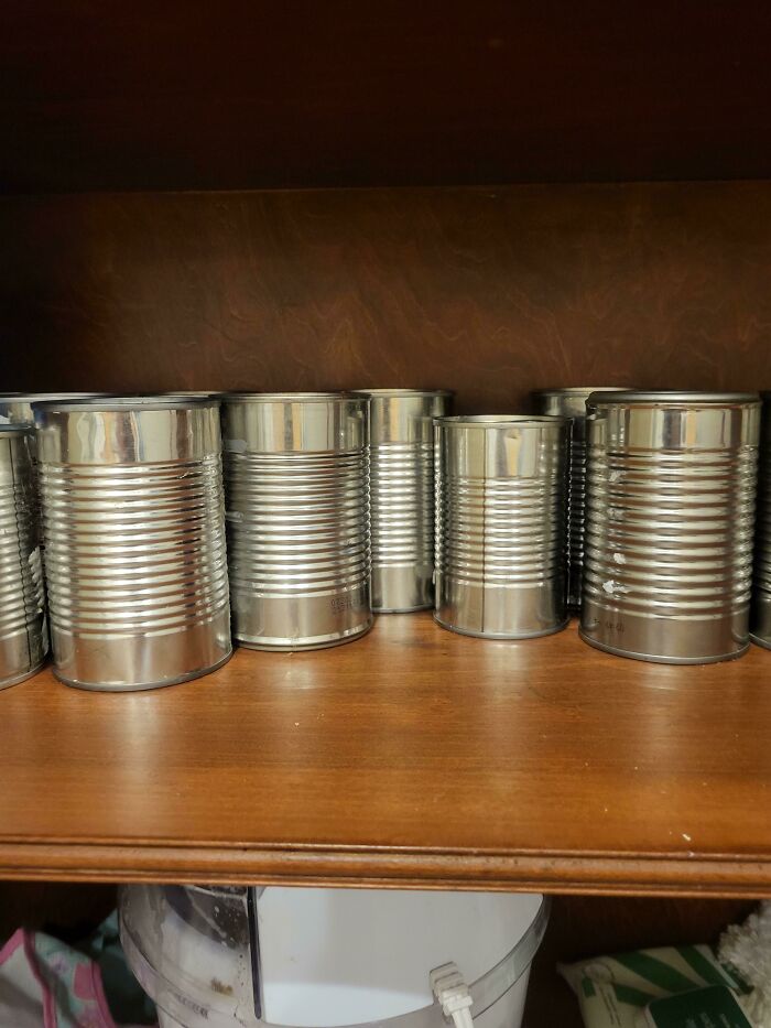 A collection of canned goods, possibly stored by mischievous kids in an unexpected way.