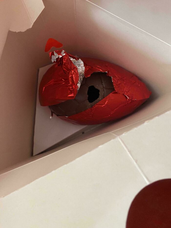 A partially eaten chocolate Easter egg, still in its red foil wrapper, shows mischievous kids who gave parents a headache.