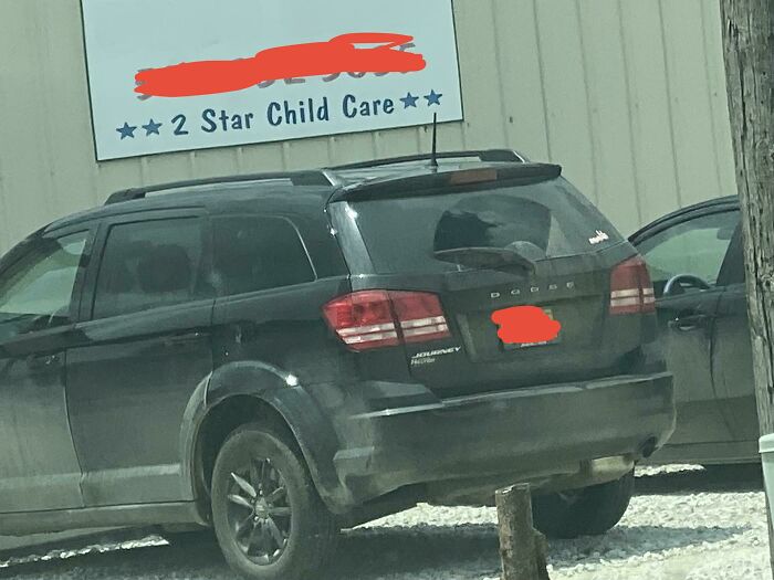 A black SUV parked in front of a 2 Star Child Care sign, showing how mischievous kids lead to parents' headaches.