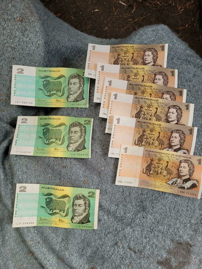 Old Australian one and two dollar notes spread on a blue towel, a nostalgic Aussie memory that brings back the Australia many grew up with.