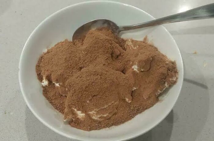 A white bowl filled with Milo powder and ice cream, a nostalgic Aussie memory that brings back the Australia many grew up with.