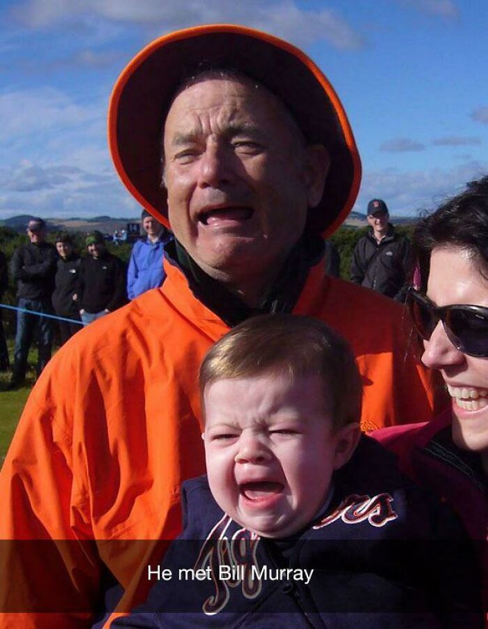 Hilarious baby crying while being held by a woman, with Bill Murray in the background, making parents laugh.