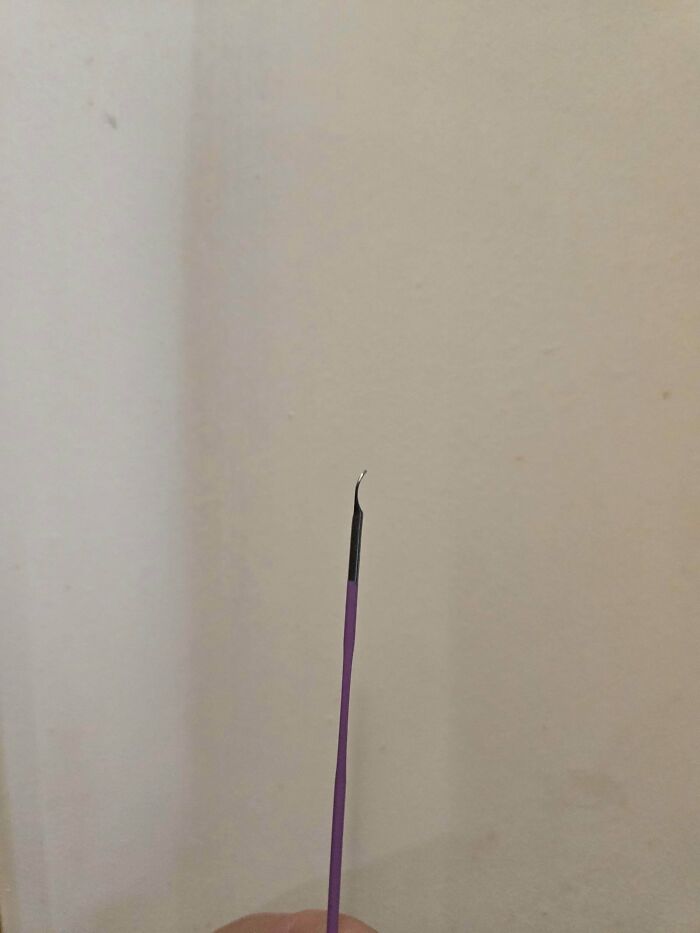 Close-up of a bent incense stick, likely broken by mischievous kids, giving parents a headache.