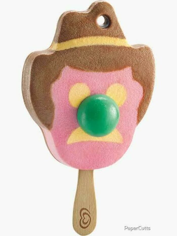 An ice cream bar shaped like a cowboy with a brown hat and pink face, bringing back Aussie memories.