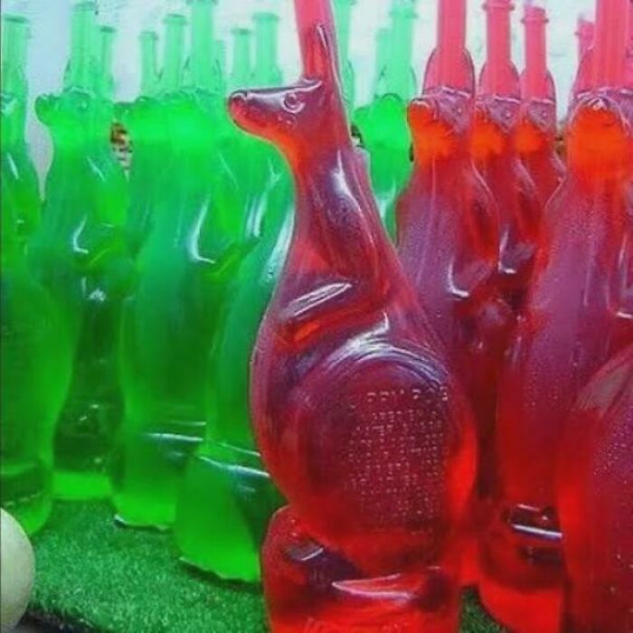 Rows of green and red kangaroo-shaped bottles filled with liquid, a nostalgic Aussie memory of treats.