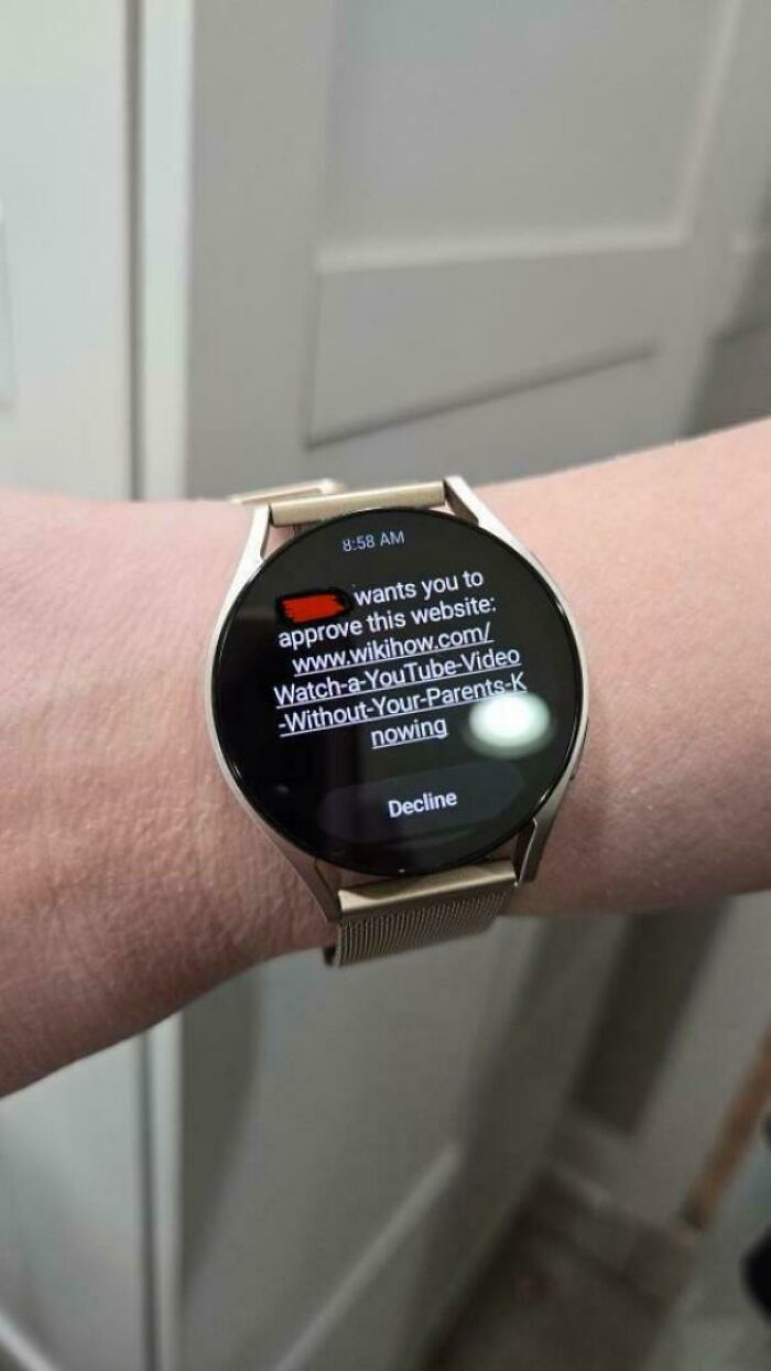 A smartwatch displaying a request to approve a wikihow link, a mischievous kids moment that makes parents laugh.