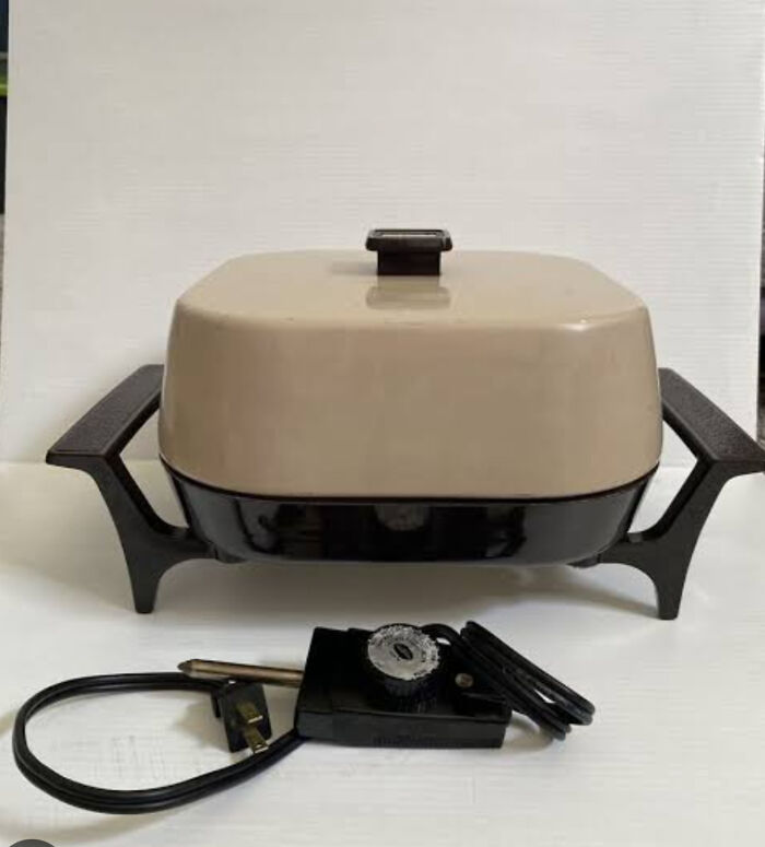 A vintage beige and black electric skillet with its temperature control, a nostalgic Aussie memory.