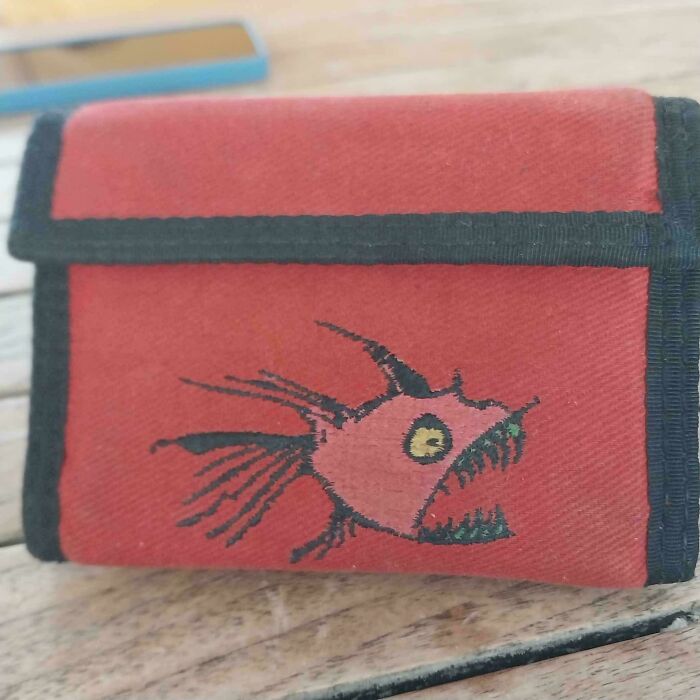 A red fabric wallet with a drawing of a fierce fish, a nostalgic Aussie memory for many Australians.