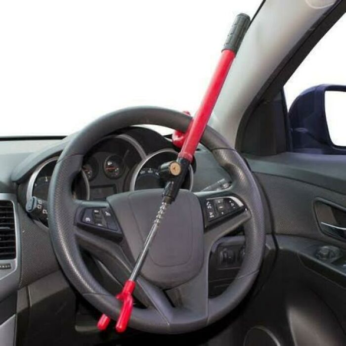 A red anti-theft steering wheel lock attached to a car, a nostalgic Aussie memory.