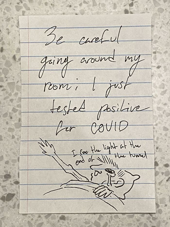 A handwritten note on lined paper by mischievous kids, stating a COVID-19 positive test.
