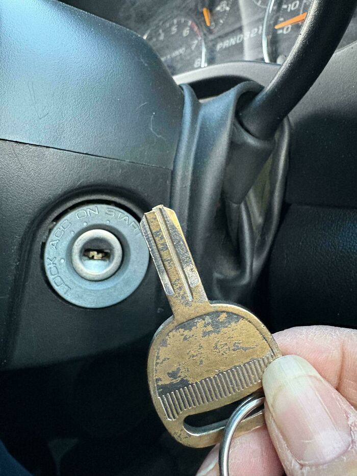 A close-up of a broken car key held near an ignition, a result of hilarious and mischievous kids.