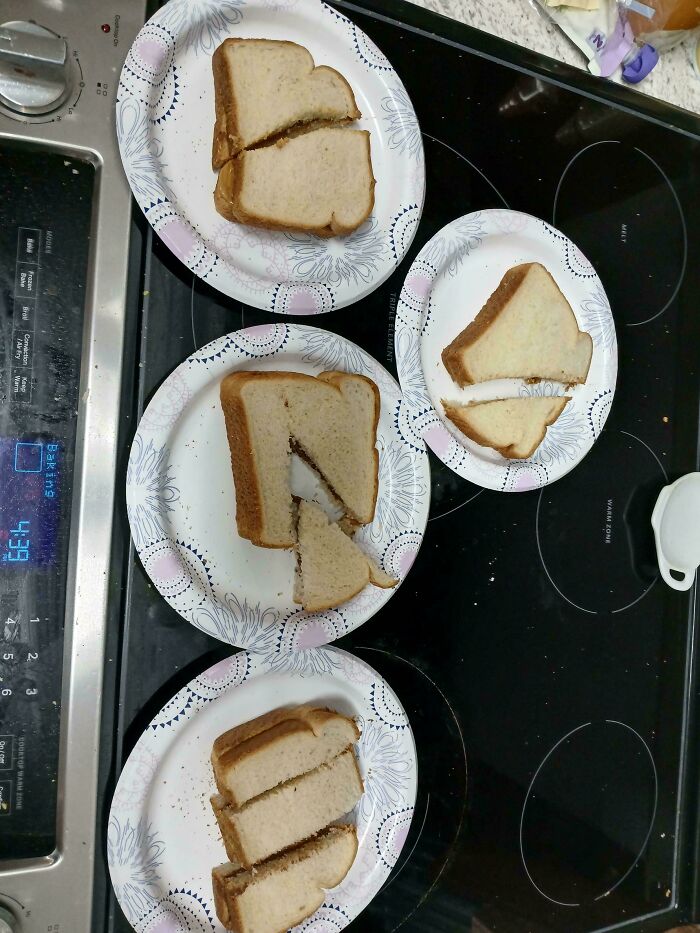 A top-down view of multiple plates with mischievously cut sandwiches, showing kids creative, hilarious antics.