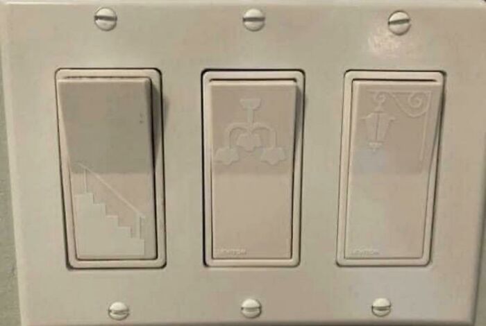 Light switches with etched icons of stairs, a chandelier, and a lantern, showcasing practical product designs.