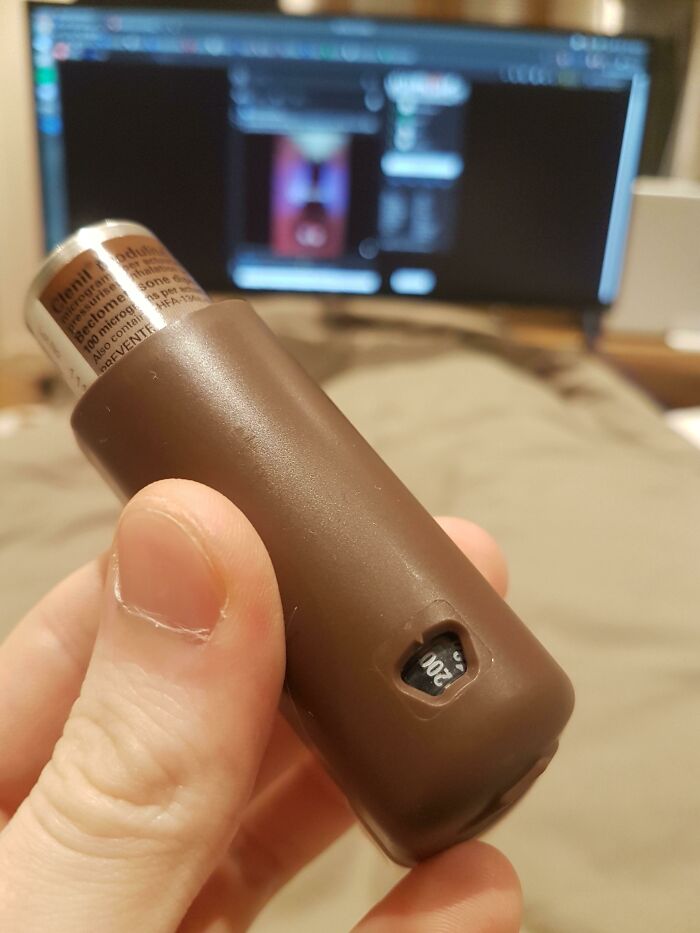A hand holding a brown inhaler with a dose counter showing 200, an example of practical product designs.
