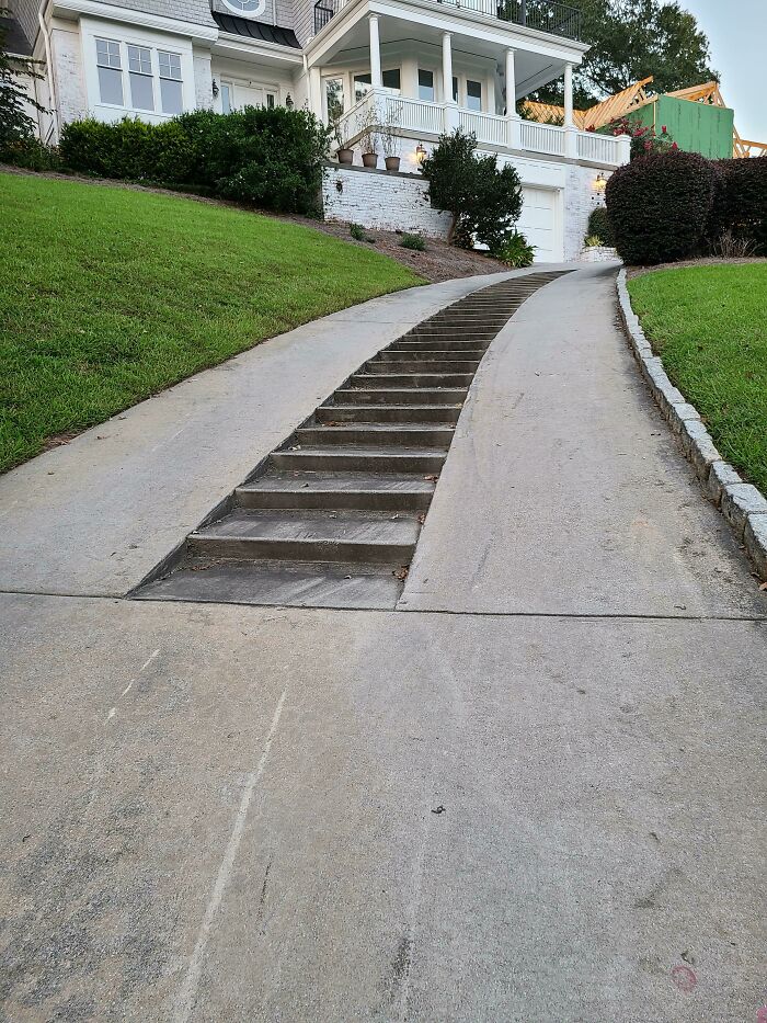 A long driveway with a section of stairs in the middle, leading up to a house. An example of practical product designs.